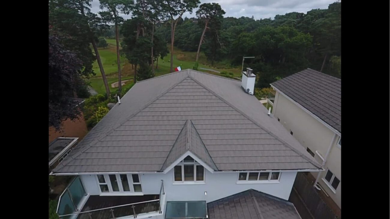 Grey tiled home clean after soft wash with gold course behind garden