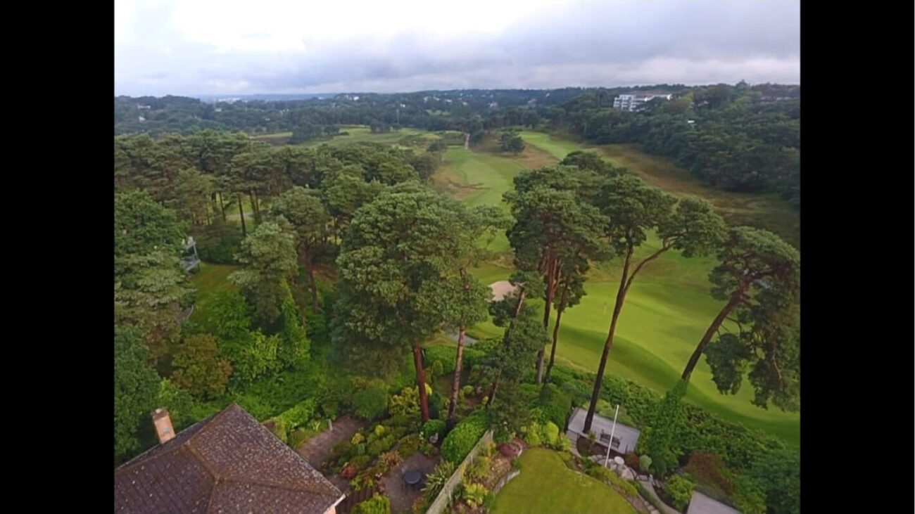 Aerial panoramic view of UK golf course from rear of home