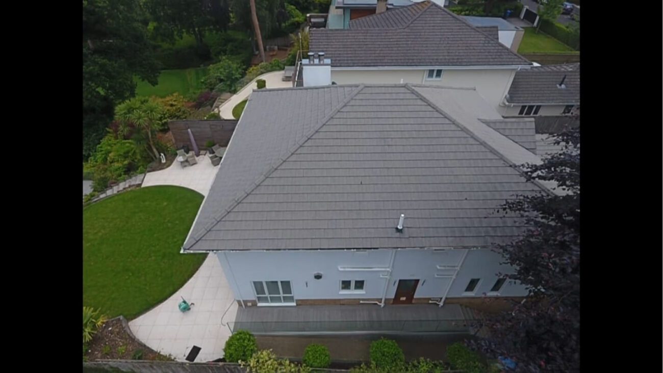 Soft washed roof tiles dried on white residential home