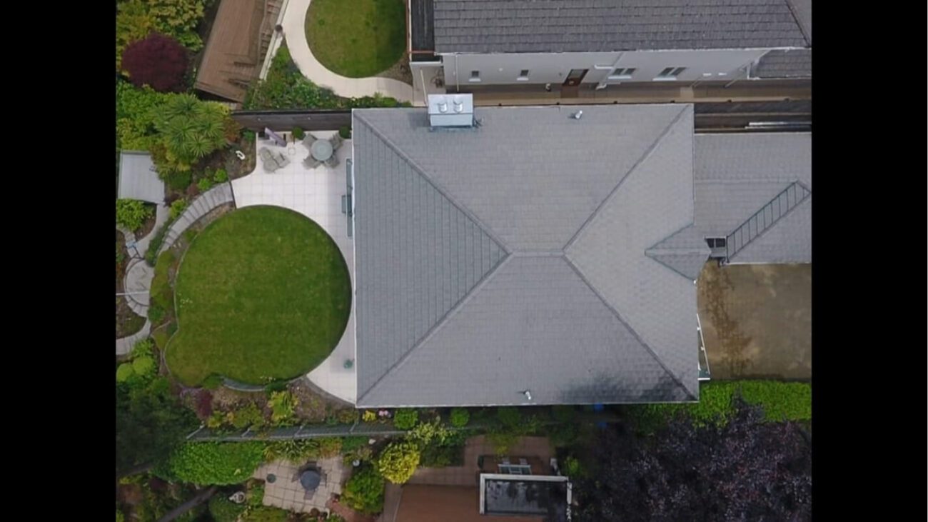 Aerial drone shot of recently soft washed grey tile roof