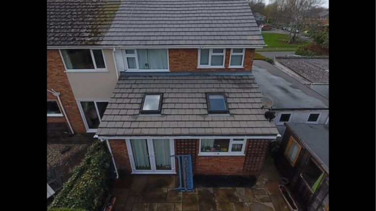 Garden view of shingle roof drying after being restored via soft wash