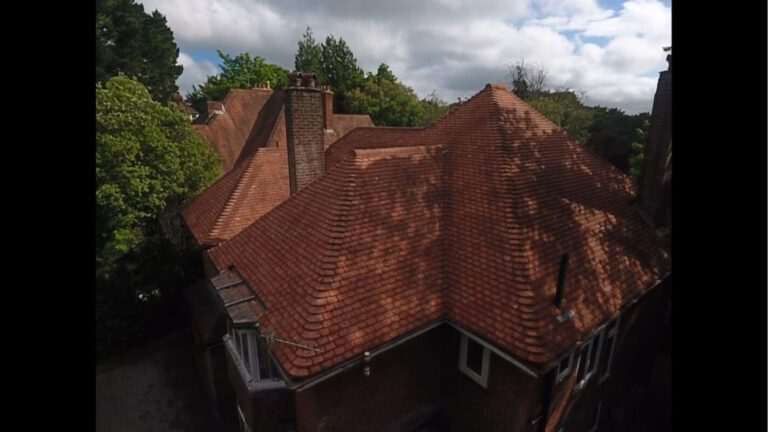Side on view of soft washed roof tiles on a Dorset home