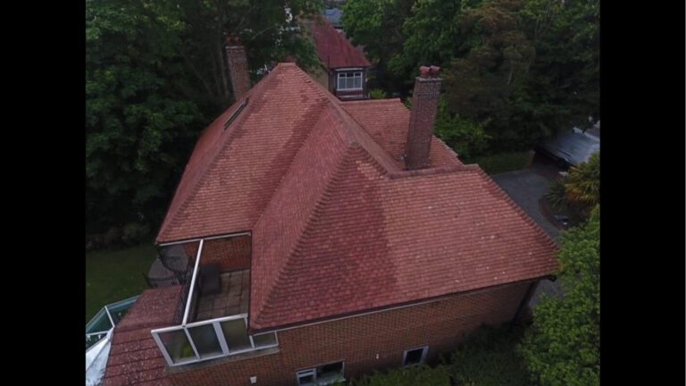 Post clean red brick home with red roof tiles drying in the sun