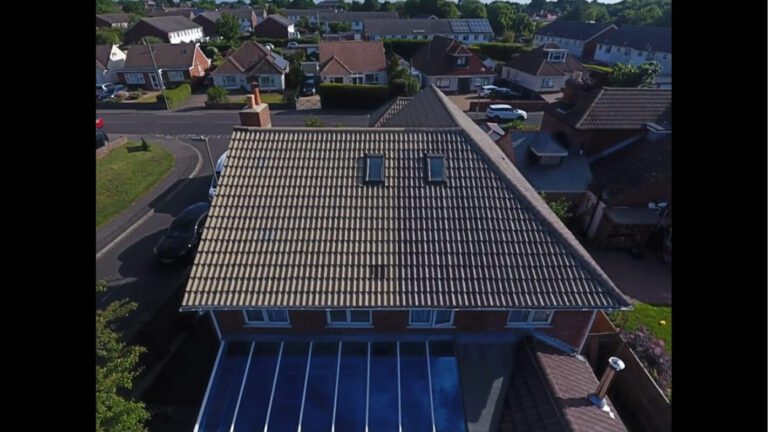 Progress of a residential home roof being soft washed