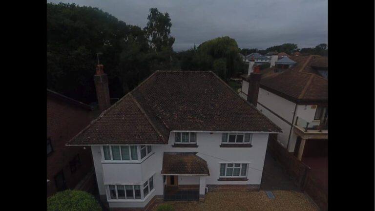 frontal view of dirty moss covered roof in Dorset
