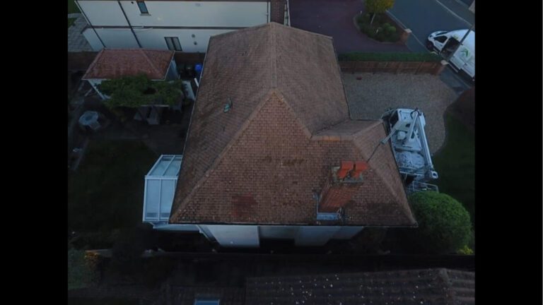 tiled roof with chimney recently cleaned of all moss
