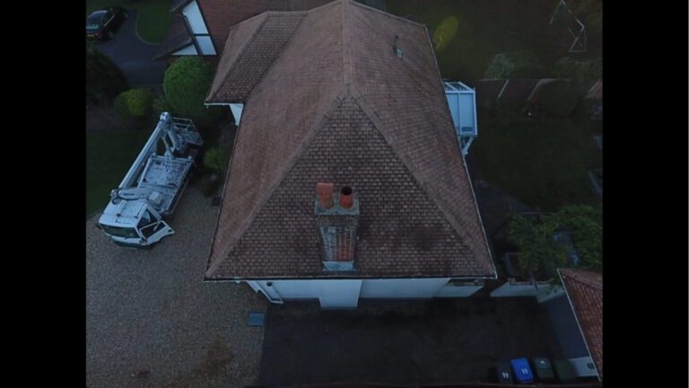 Side on view of uk home with cleaned roof and chimney