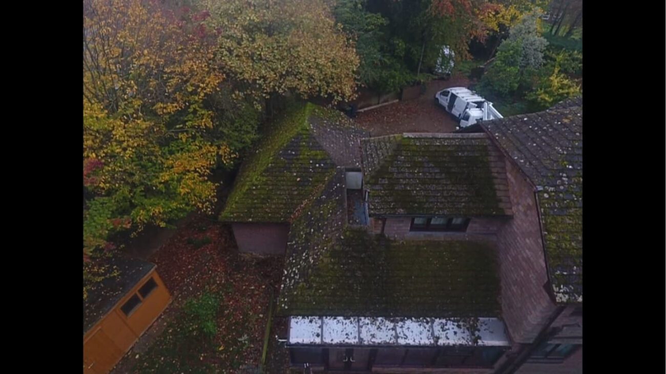 UK brick home encased in moss prior to cleaning