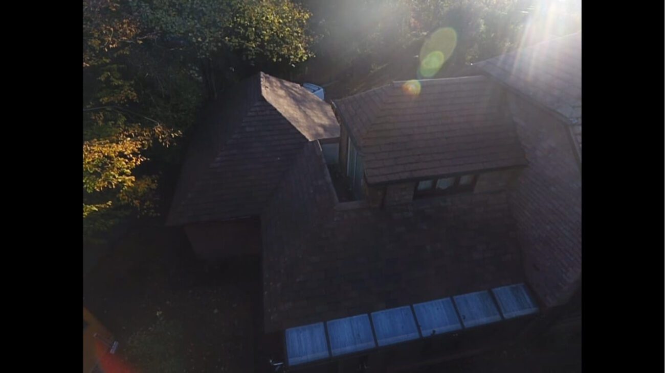 Aerial shot of previously dirty roof shining in the sun