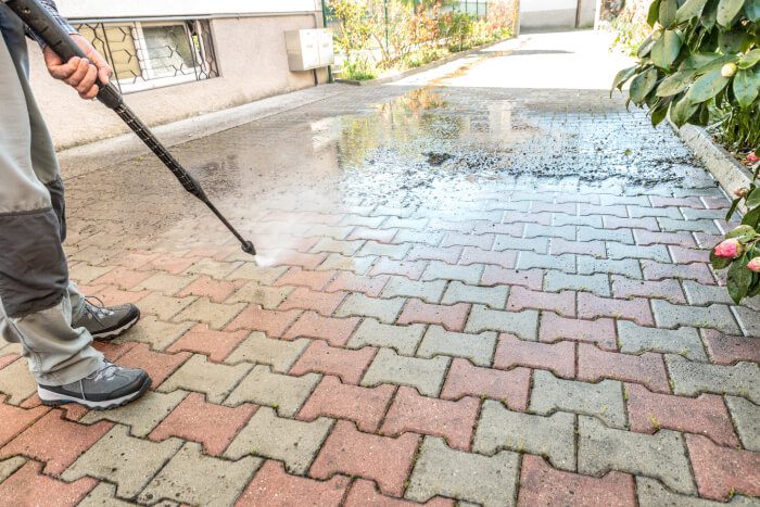 Long multi tiled driveway being cleaned by specialist