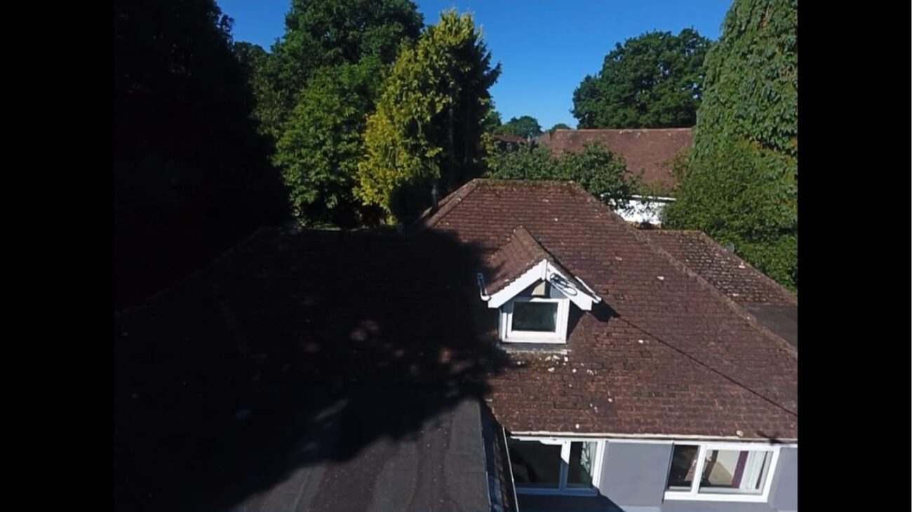 dirty bungalow roof on a sunny day with white lintels