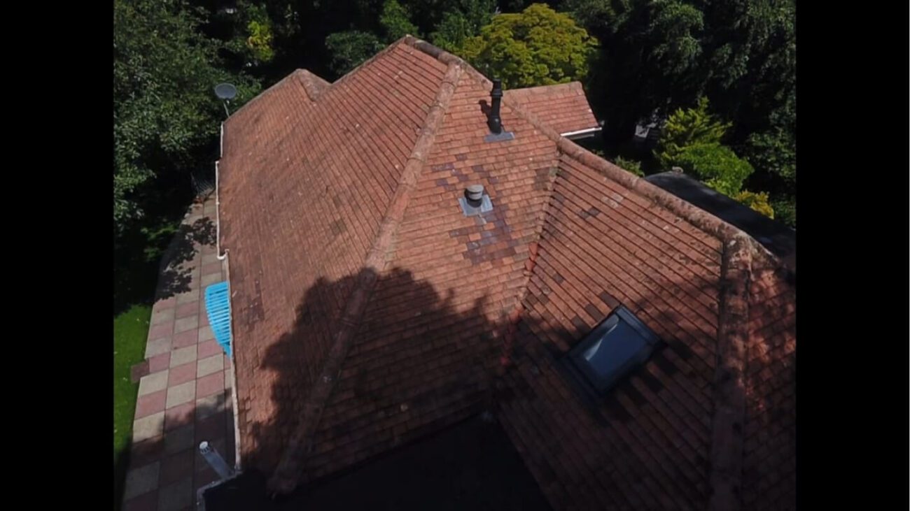 Red tiled bungalow roof freshly cleaned of all moss with soft wash