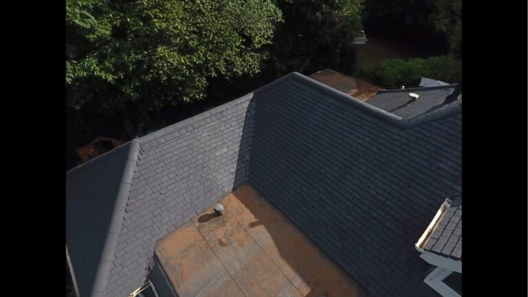 drone view of newly grey tiled roof shining in the sun after clean
